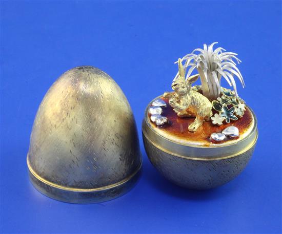 A cased early 1980s Stuart Devlin silver gilt and enamel surprise egg. 2.75in.